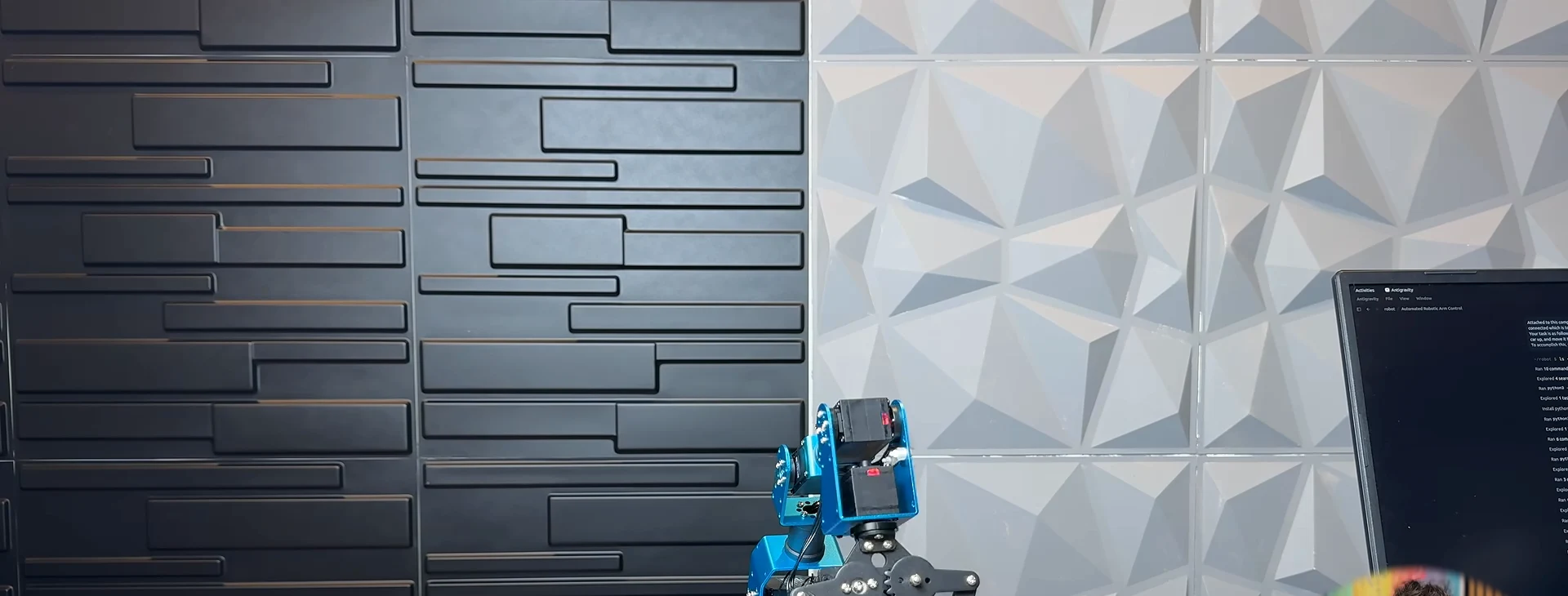 A blue robotic arm lifts an orange toy car while Gemini 3.8 Flash's Antigravity session writes the vision pipeline and pick-and-place script on the monitor behind. A blue robotic arm lifts an orange toy car while Gemini 3.8 Flash's Antigravity session writes the vision pipeline and pick-and-place script on the monitor behind.