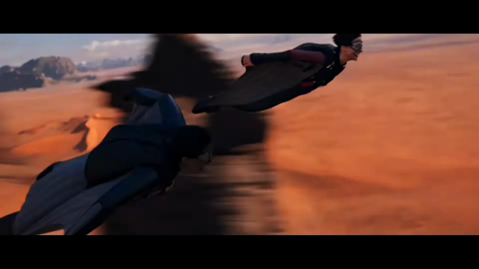 Kling 4.0 launch film frame of a wingsuit flyer landing in a desert canyon with heavy motion blur