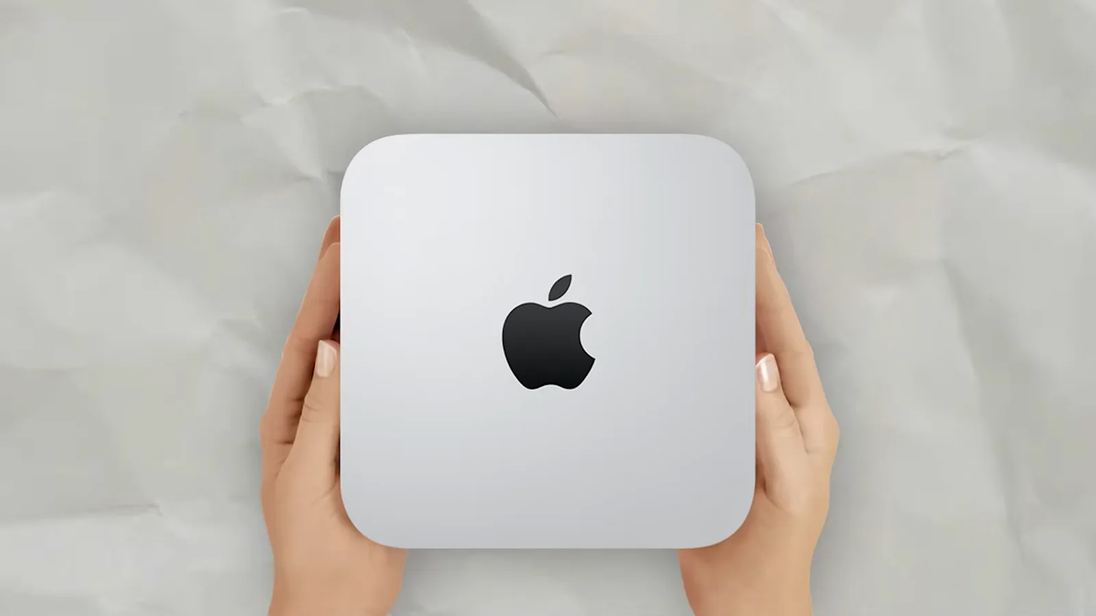 Hands holding a Mac mini positioned as an always-on host for a self-hosted OpenClaw assistant